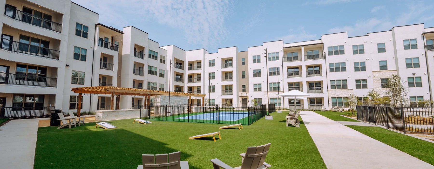 view of four story apartment building from activity courtyard