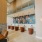 a great room with orange sitting chairs and tables