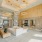 a room with a white couch and tables and chandeliers