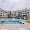 pool courtyard with white lounge chairs and green turf sections