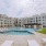 a pool courtyard with white lounge chairs
