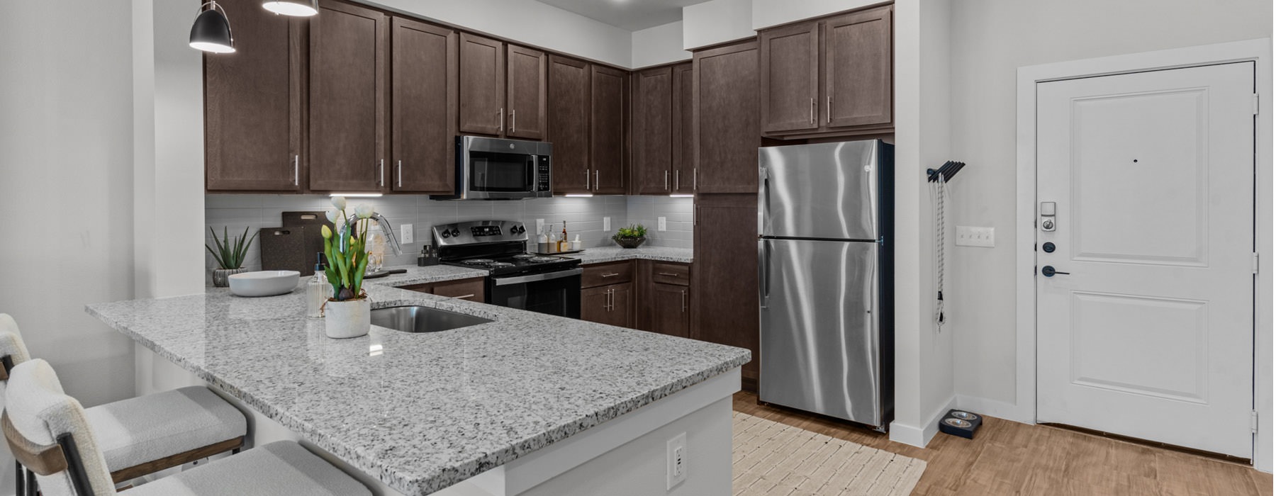 an open kitchen with stainless appliances and designer finishes